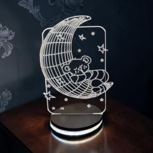 Sleeping teddy on the moon crystal lamp.
